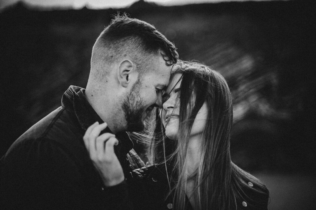 Engagement photographer Cork – romantic black-and-white close-up of a couple at the coast